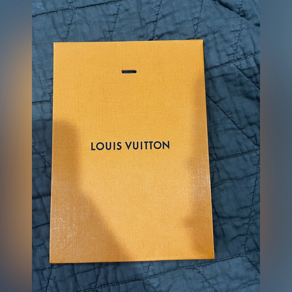 Small perfume/cologne LV shopping bag.